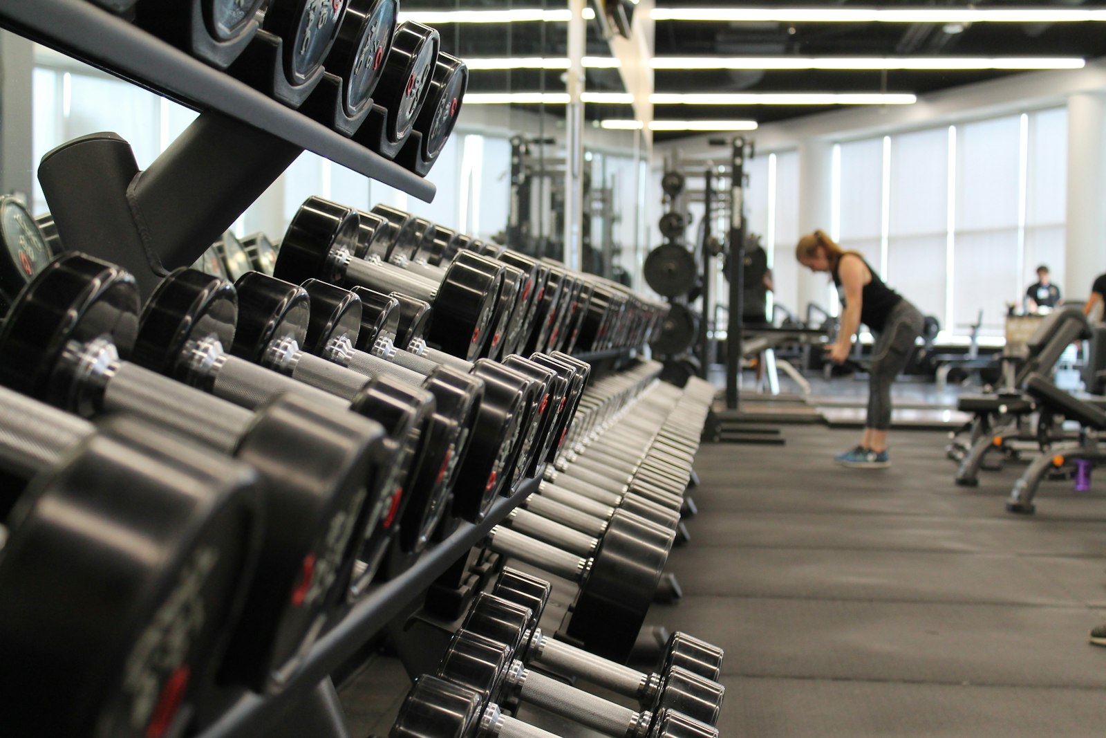 Dark, moody training floor of a premium gym
